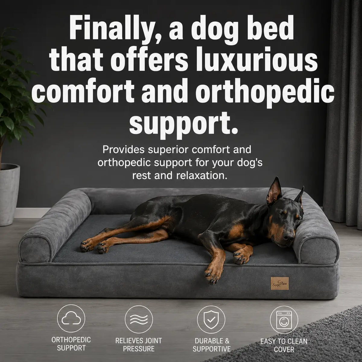 A black and tan Doberman dog lies on a plush gray orthopedic dog bed 