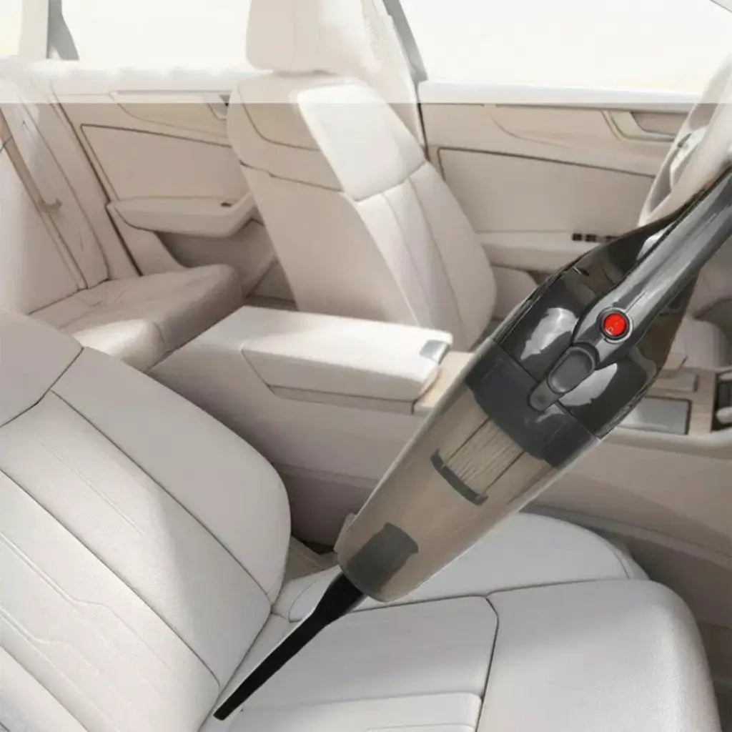Car interior with a handheld vacuum cleaner cleaning the seats