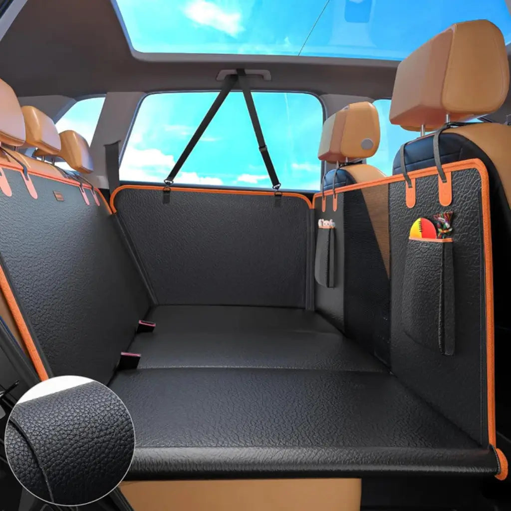 Car interior with black dog seat cover and orange accents, showing a close-up of the textured material
