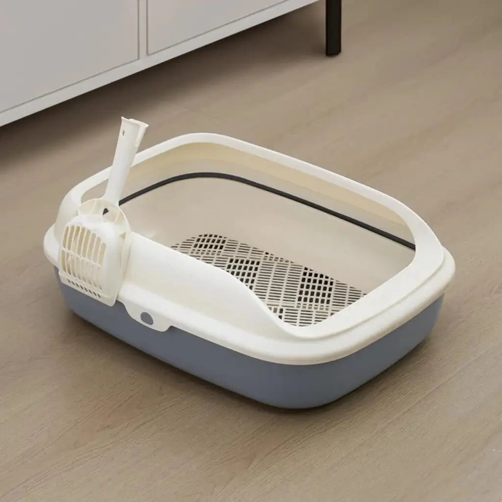 Cat litter box with a partially lifted lid on a wooden floor.