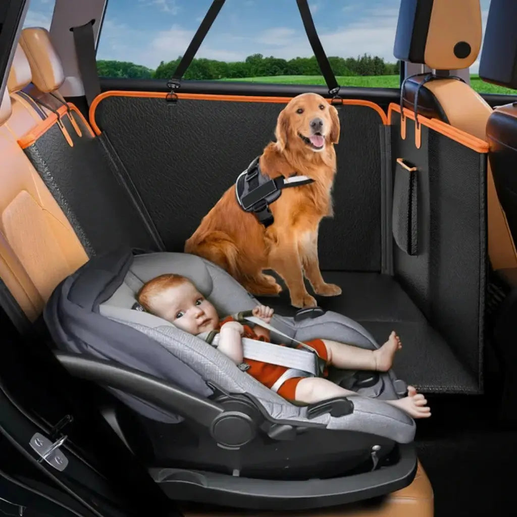 Child in a car seat and dog on the back seat  cover with a black pet barrier