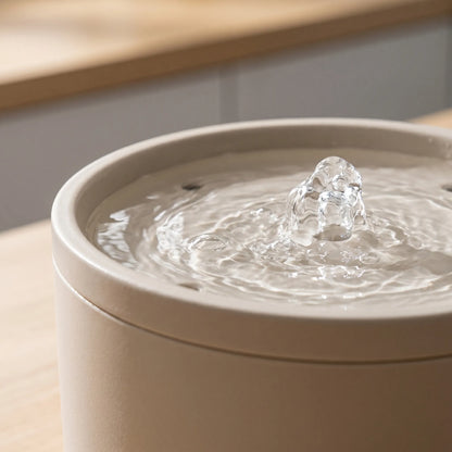 Close-up of a ceramic water fountain with water splashing.