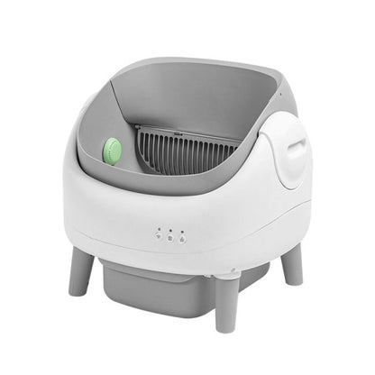 Gray and white pet litter box with a green button on a white background
