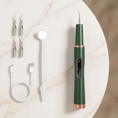 Green dental tool with attachments on a marble surface