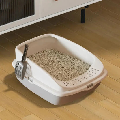 Grey Cat litter box with scoop on a wooden floor