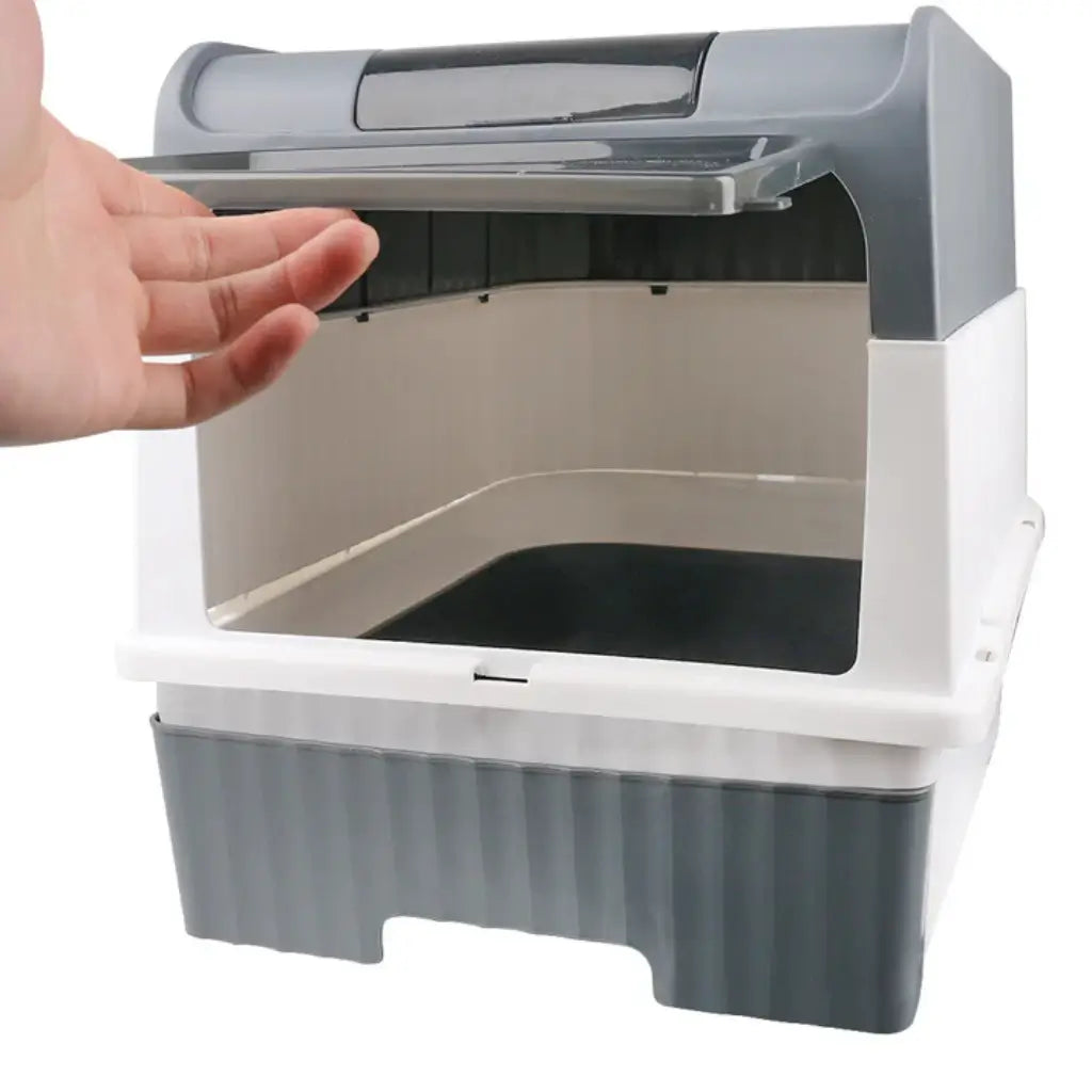Hand opening a cat litter box with a gray and white design