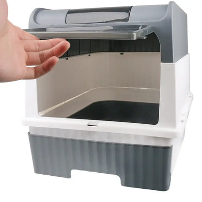 Hand opening a cat litter box with a gray and white design