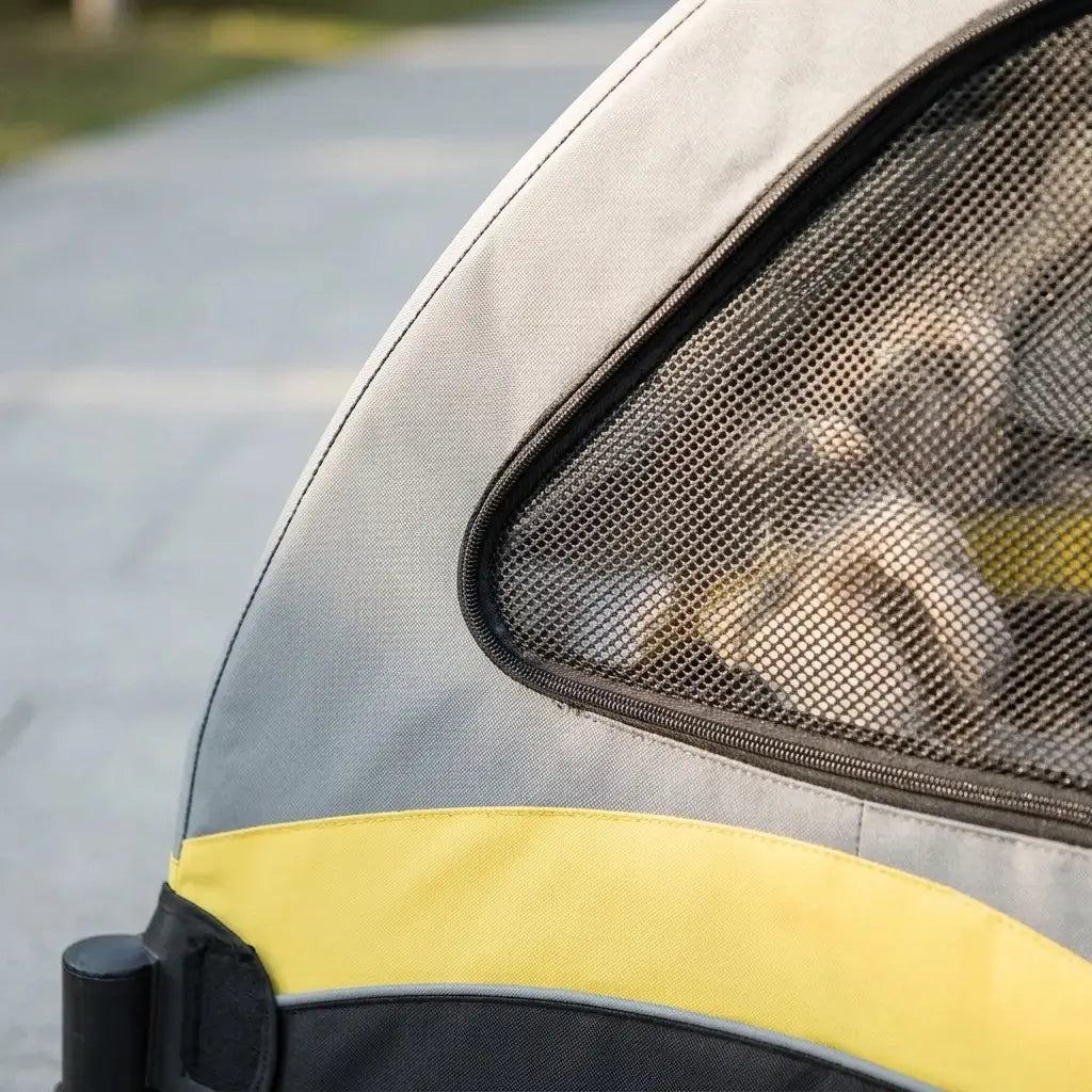 Pet stroller with a mesh window on a road background