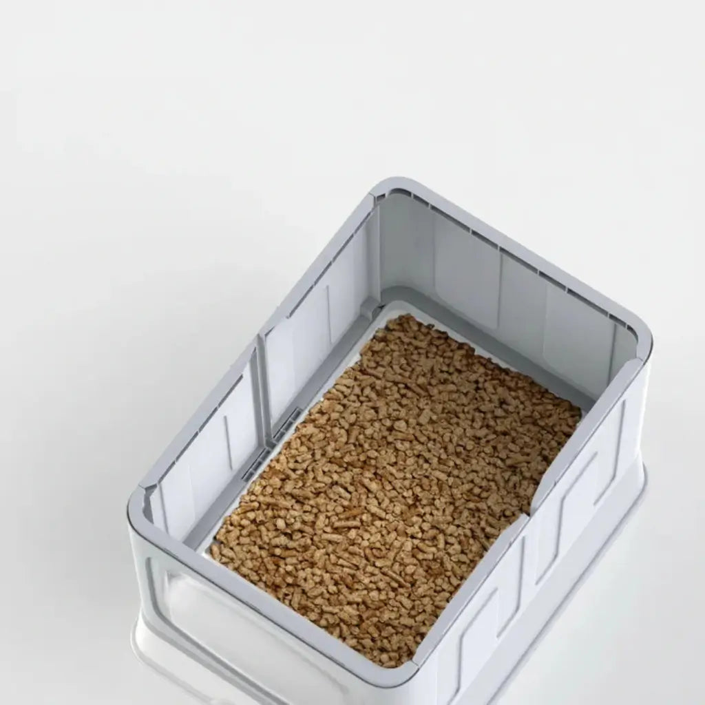 Rectangular litter box with brown litter on a white background