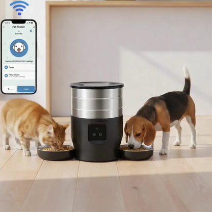 Smart pet feeder with two pets eating from bowls on a wooden floor, and a smartphone app displayed
