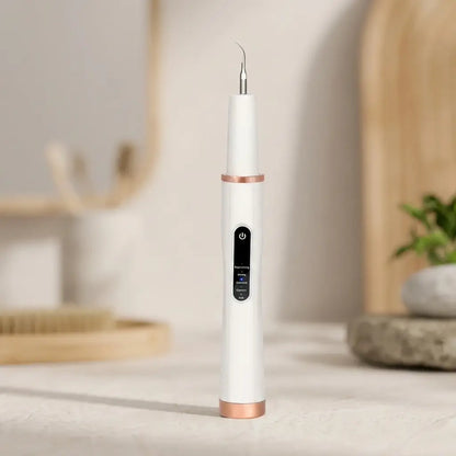 White and rose gold dental tool on a neutral background