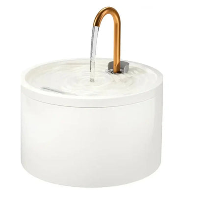 White ceramic cat water fountain with a copper faucet on a white background