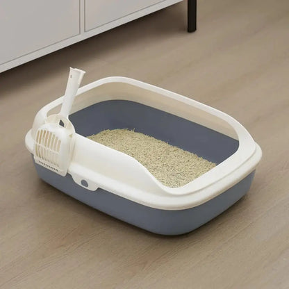 XL Cat litter box with a white top and gray base on a wooden floor.